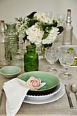 A table laid with green and white accessories