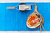 Penne with pumpkin-tomato sauce; parmesan cheese