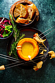 Cheese fondue in a Hokkaido pumpkin with baguette and salad
