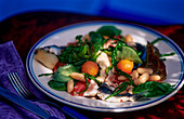 Salad with vegetables, fish and ham