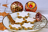 Cinnamon stars arranged with Christmas decorations