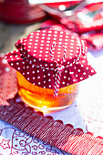 Single jar with red and white dotted fabric over the lid