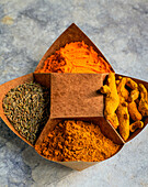 Various spices in origami paper bowls