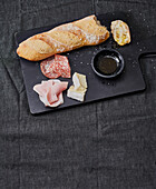 Baguette with salami, ham and camembert; dipping oil