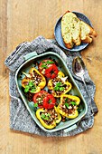 Stuffed tomatoes and peppers with garlic bread