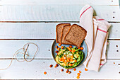 Hazelnut-carrot spread with cucumbers and slices of bread