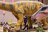 Workers Assemble Dinosaurs for Detroit Auto Show