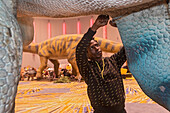 Workers assembling dinosaurs for Detroit Auto Show, USA