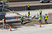 Workers repairing a highway