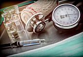 Vials next to a manometer and stethoscope, conceptual image