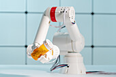 Robotic arm holding bottle of tablets