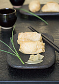 Inari Sushi (deep-fried tofu pockets filled with rice) with gari (ginger)