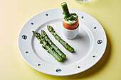 Asparagus tips with a soft boiled egg and chives