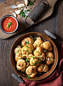 Garlic knots topped with parsley and grated romano cheese