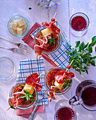 Piperade (Basque pepper sauce) and skewers with sausage, ham and cheese