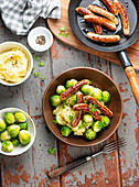 Fried sausages with Brussels sprouts and mashed potatoes