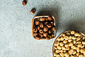 Bowl full of hazelnuts on concrete background