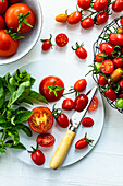 Assorted tomatoes in bowls and on a cutting board