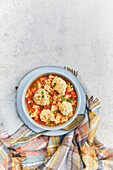 Bowl of vegetable stew with herb parmesan dumplings