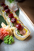 Sushi roll with tuna, ravokado fish and ed souce