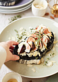 Figs and goat cheese on sourdough bread with charcoal