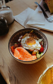 Salad bowl with smoked salmon and fried egg