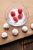 Roll raspberry crinkles in icing sugar