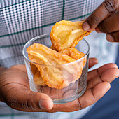 Hand removing dried pear from bowl