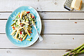 Pasta with green asparagus, peas and tomatoes