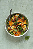Green leaf salad with persimmon and halloumi