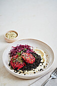 Vegetable patties with beluga lentils and marinated red cabbage