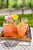 Rhubarb punch in glasses on a mirror tray
