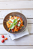 Pasta with paprika sauce, feta, and walnuts
