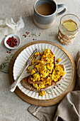 Turmeric stir-fry on sourdough bread with red peppercorns and a cup of coffee