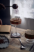 Chocolate mousse in a stemmed glass is dusted with cocoa powder
