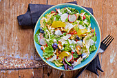 Mixed leaf salad with oranges, radishes, and parmesan cheese