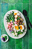 Lukewarm asparagus salad with potatoes and boiled egg