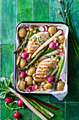 Oven-baked chicken breast with potatoes and vegetables