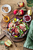 Apple and avocado salad with pomegranate seeds and walnuts