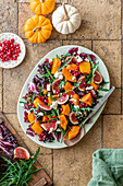 Autumnal pumpkin and fig salad with pomegranate seeds