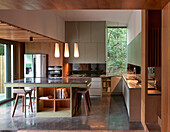 Kitchen island with bar stools in concrete house