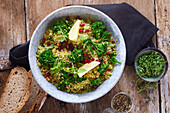 Couscous with broccoli and pomegranate seeds