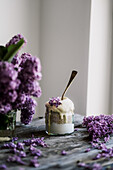 Banana dessert with yoghurt-amaranth and lilac flowers