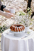 Spring bundt cake with icing on a garden table
