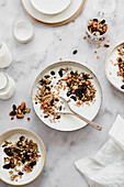 Yogurt with granola on marble table