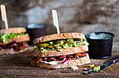 Sandwich with bacon, onion, avocado, lettuce and jalapenos