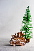 Bus shaped cookie and xmas tree on concrete background