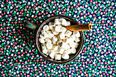 Mini marshmallows with cinnamon stick in ceramic bowls