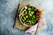 Summer vegetable salad with okra and sesame seeds, served with vine tomatoes