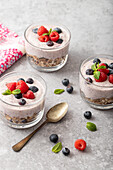 Layered desserts: granola, blueberry yogurt, blueberries, raspberries, fresh mint